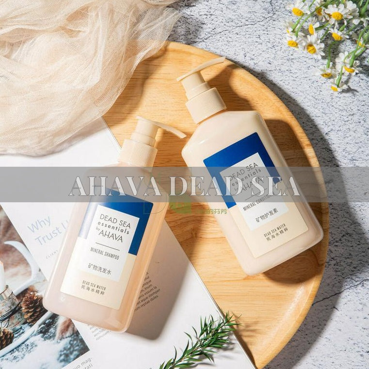 two bottles of ahava shampoo and conditioner lying on the tray.